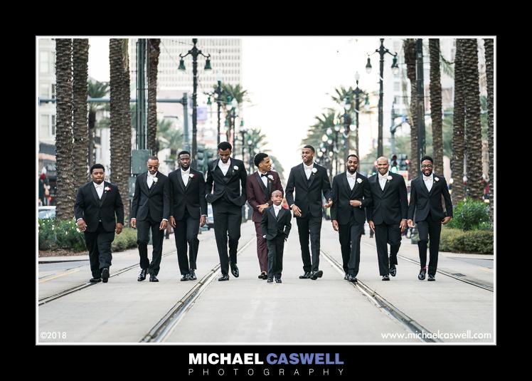 Groom and groomsmen walking down Canal Street