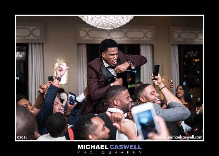 Groom lifted up and singing during reception