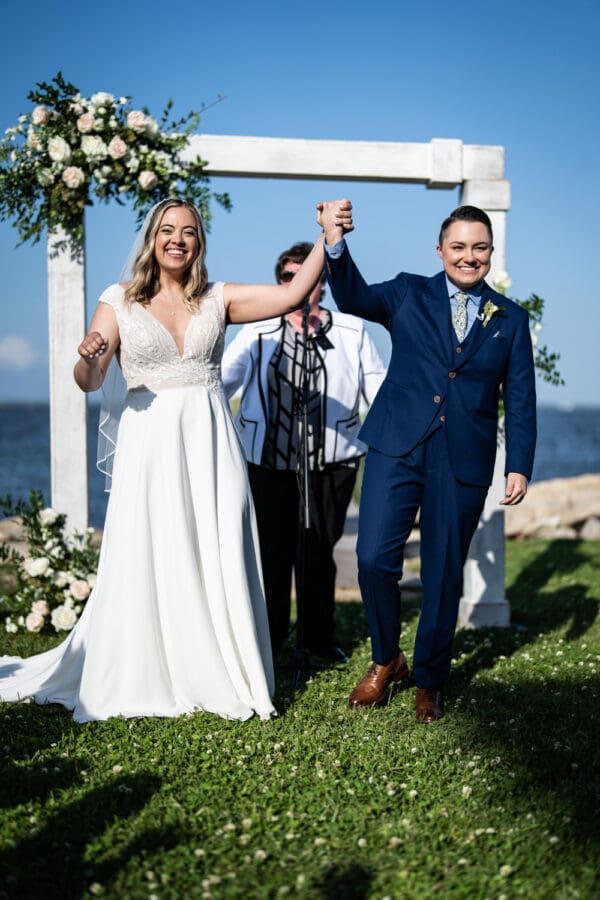 Brides celebrate at conclusion of Bay Waveland Yacht Club wedding ceremony