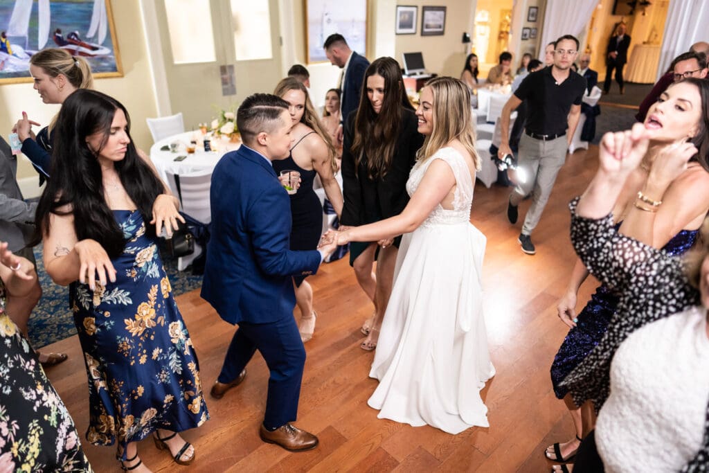 Couple and guests dance at Bay Waveland Yacht Club wedding reception