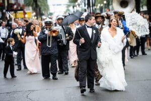 Bride and groom parade down Canal Street in New Orleans