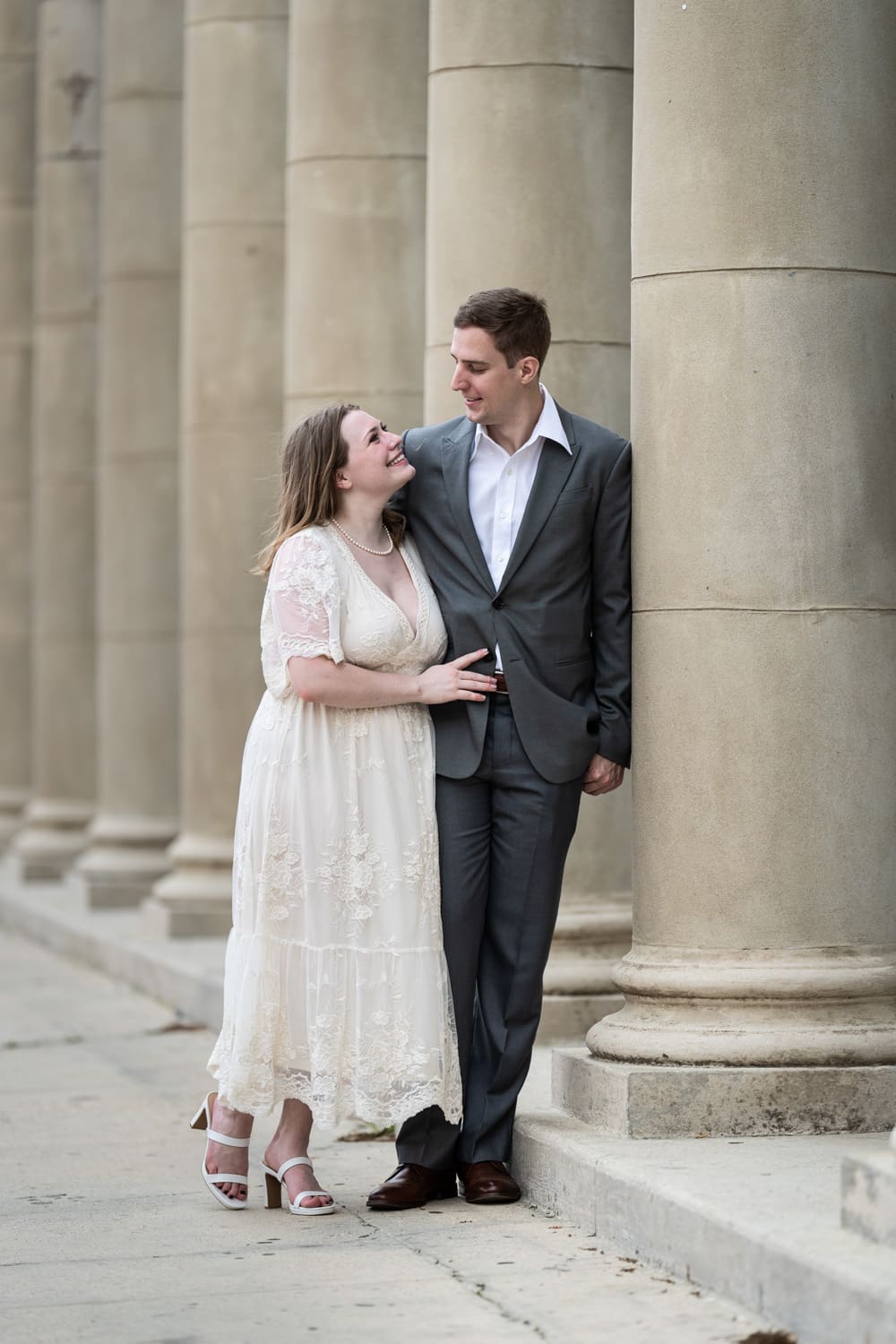 Bride and groom standing by columns in City Park