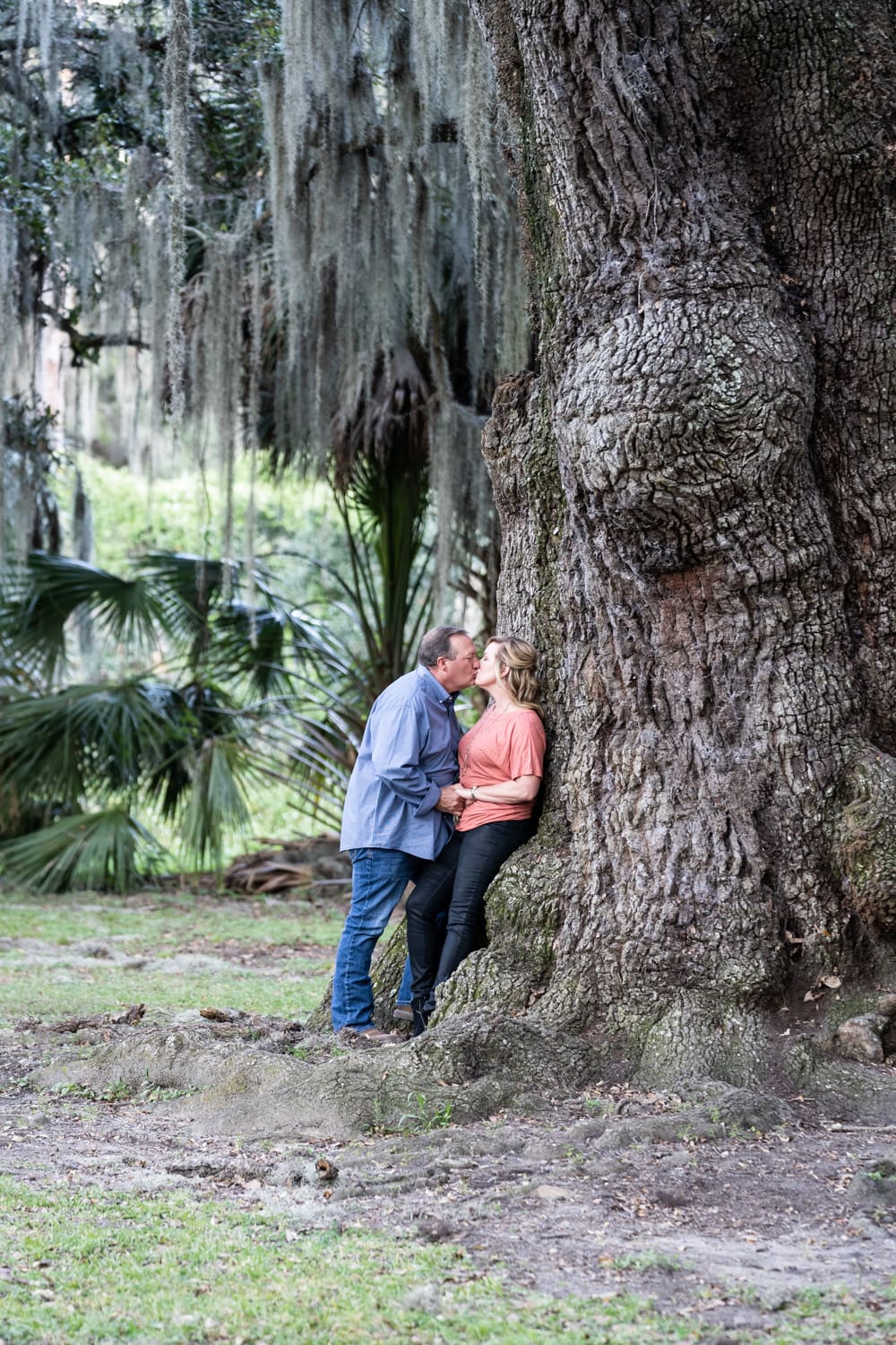 Couple in New Orleans City Park by large tree