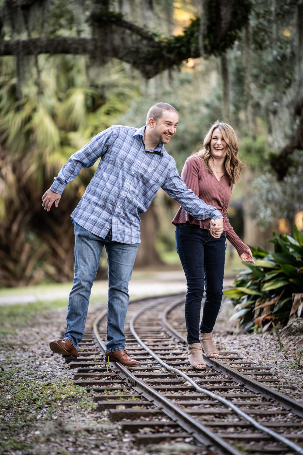 City Park engagement portrait couple on tracks