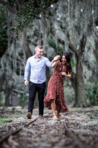 Bride and groom walking along railroad tracks in City Park