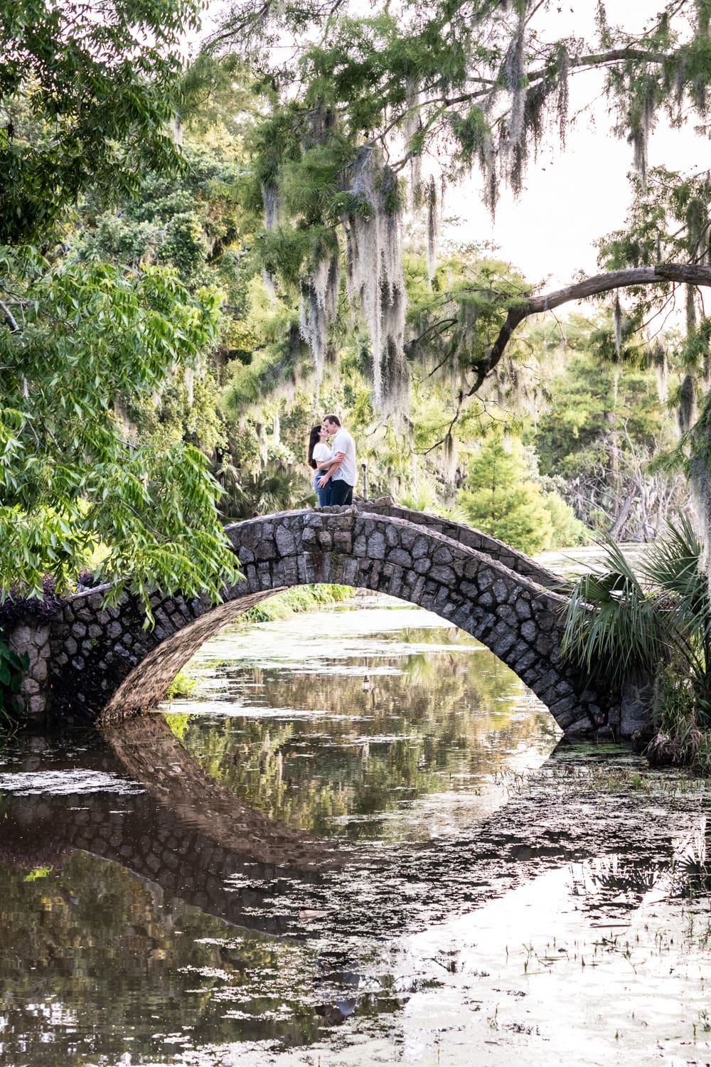 Couple kissing on the Langles Bridge in New Orleans City Park