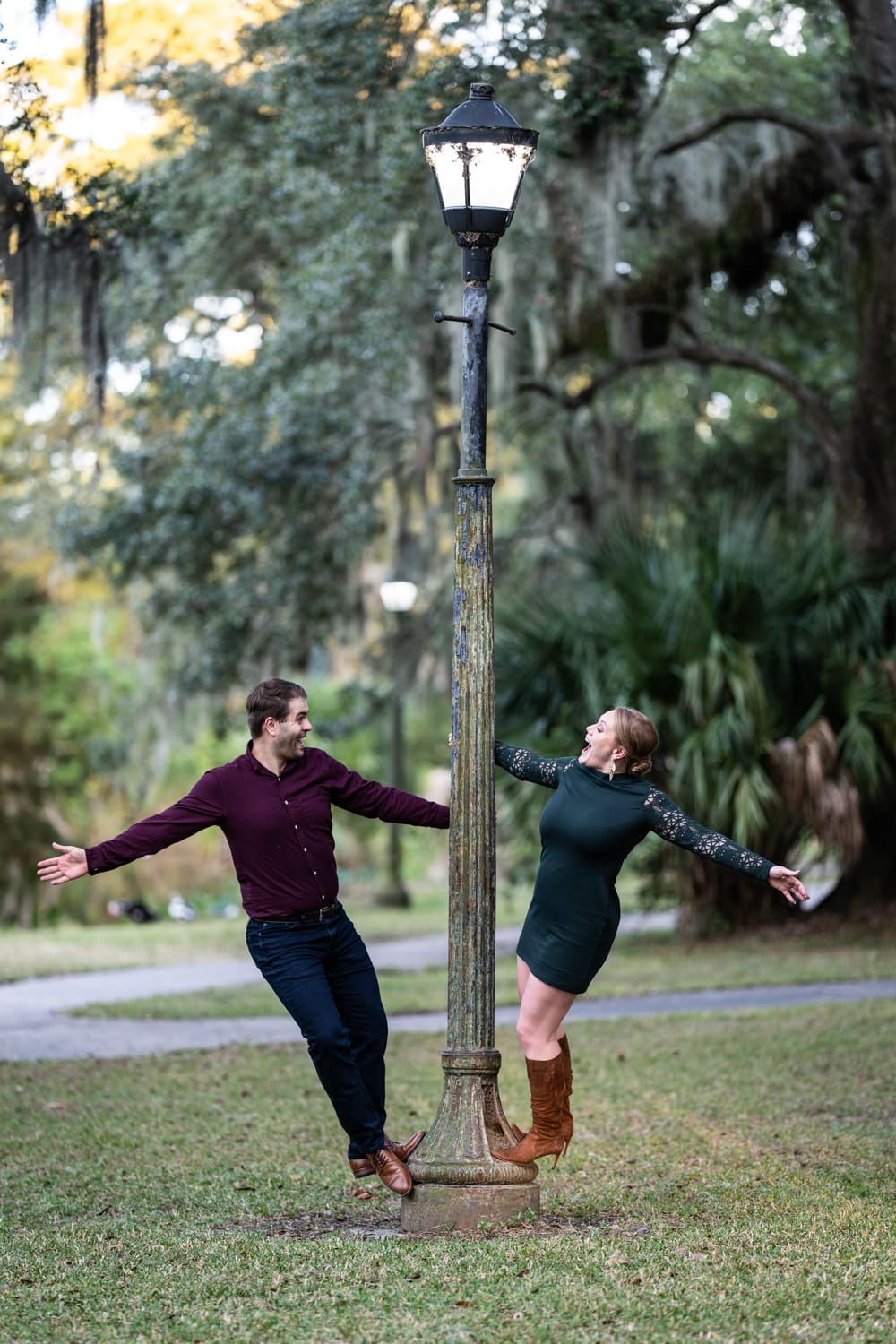 Couple hanging on to lamp post in City Park