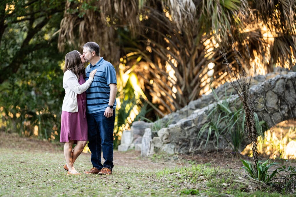 Couple kissing with bridge in the background