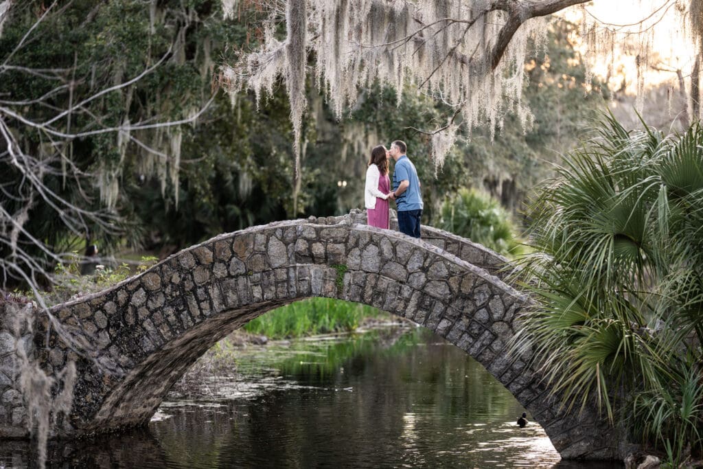 Couple kissing on Langles Bridge in New Orleans City Park