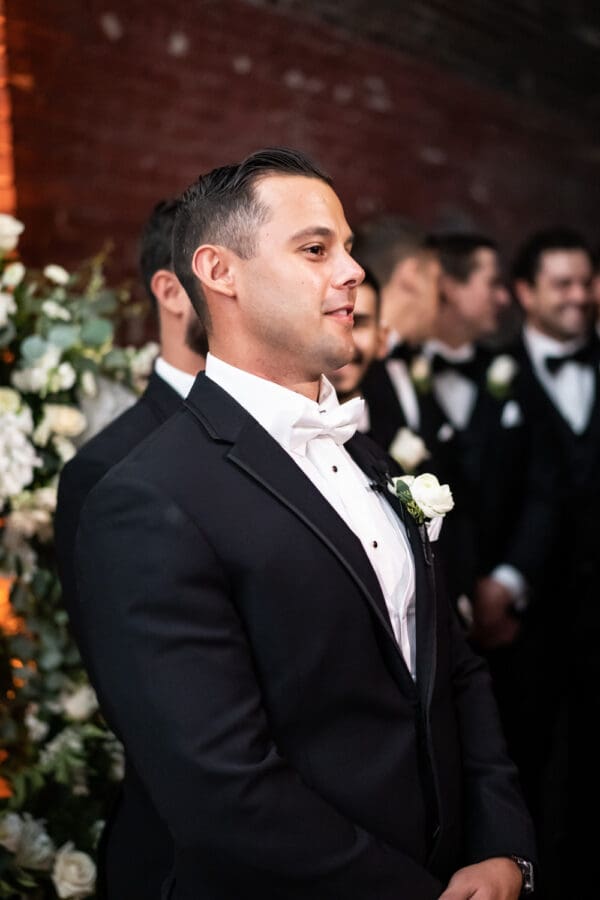 Groom sees bride coming down aisle at Civic Theatre