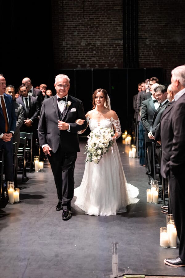 Bride and father walking down aisle at Civic Theatre wedding ceremony