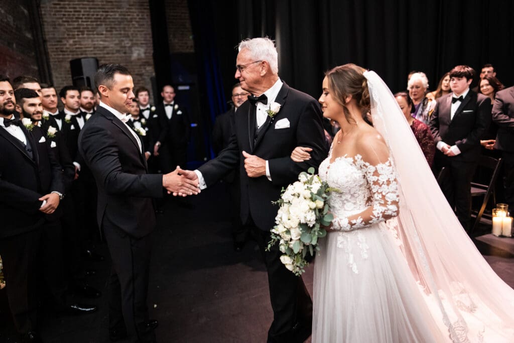 Groom shakes hand with bride's father at Civic Theatre wedding