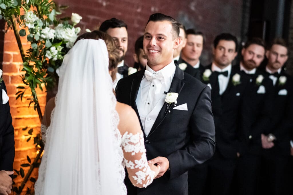 Groom smiling during wedding ceremony at Civic Theatre