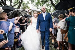 Bride and groom wedding ceremony in rain at Compass Point