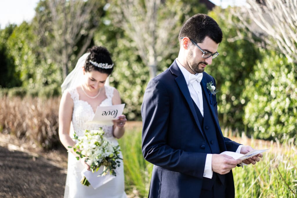 Bride and groom privately reading vows right before first look in Crescent Park