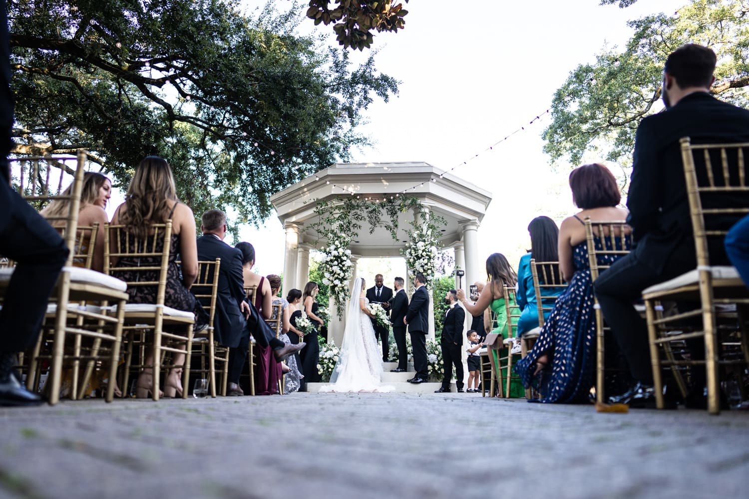 Bride and groom standing in gazebo at Elms Mansion wedding ceremony