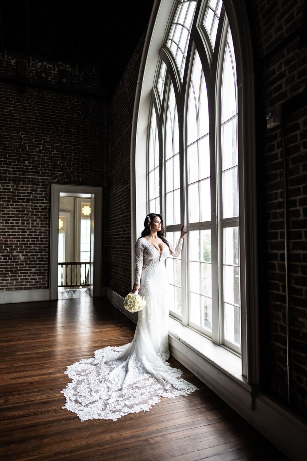 Bride looking out large window at Felicity Church wedding venue