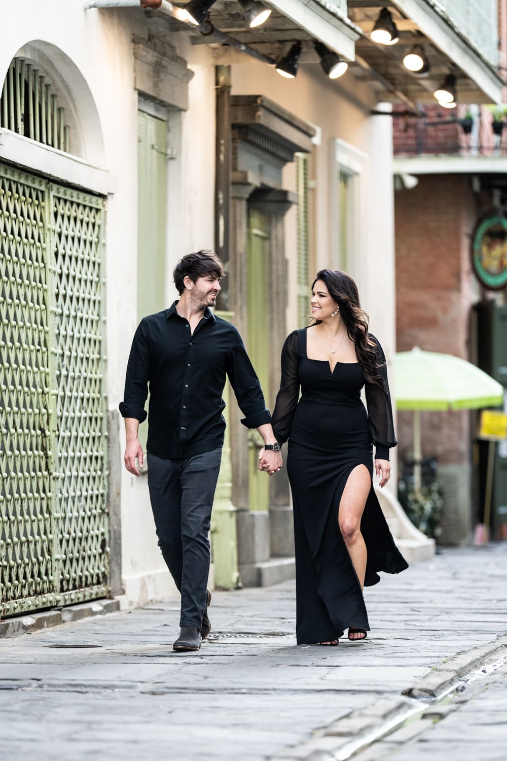 Couple walking through Pirate's Alley in New Orleans