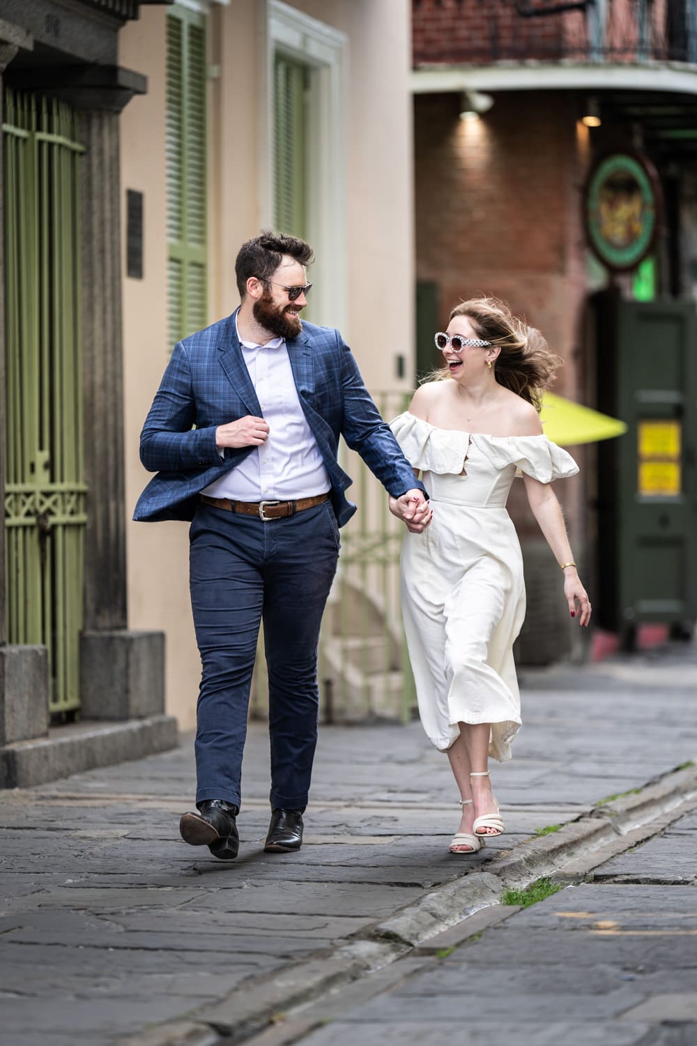 Couple walking down Pirate's Alley in the French Quarter