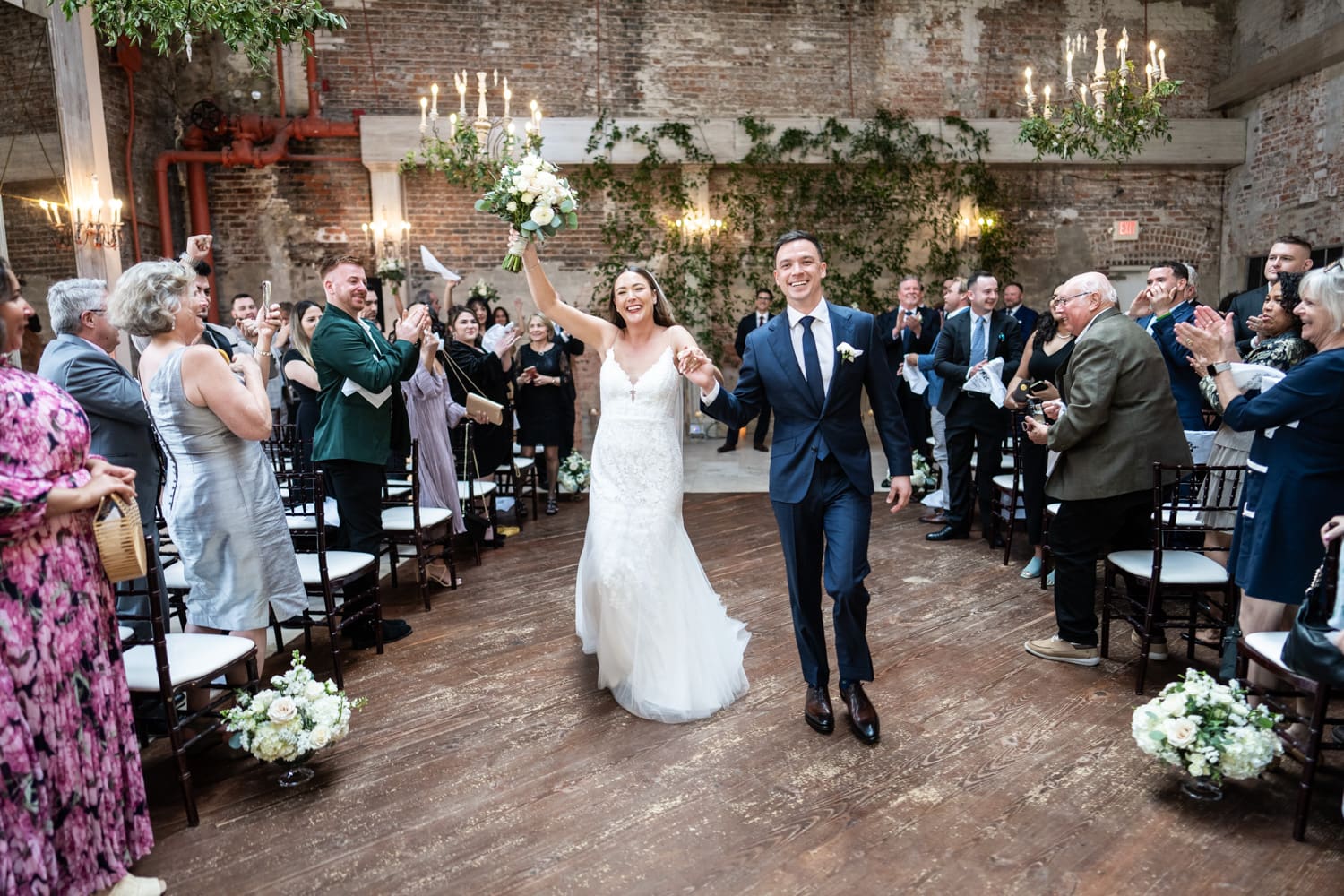 Bride and groom walking down aisle at Gallery Venue wedding ceremony