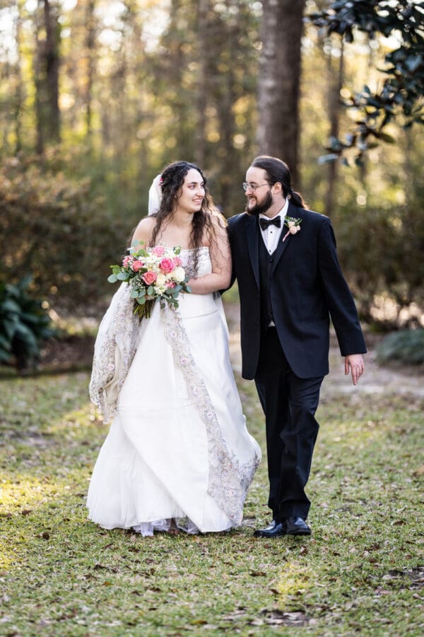 Bride and groom walk through lawn at Henry Smith House wedding