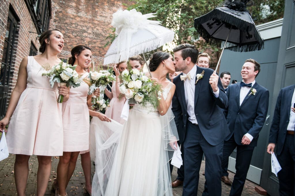 Bride and groom with second line umbrellas at Hermann-Grima House wedding