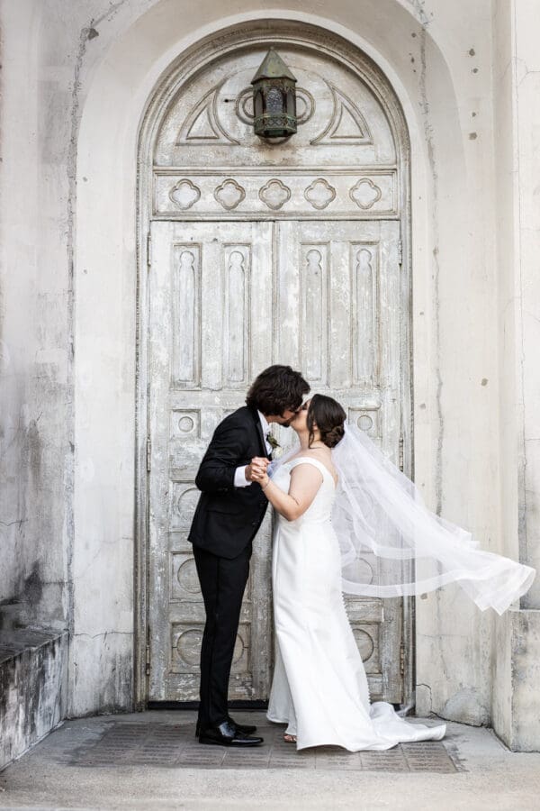 Bride and groom kiss in doorway at Hotel Peter and Paul wedding