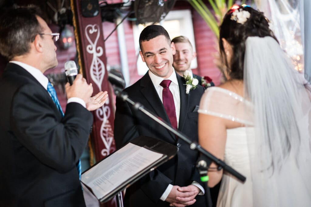 Groom smiles during wedding ceremony