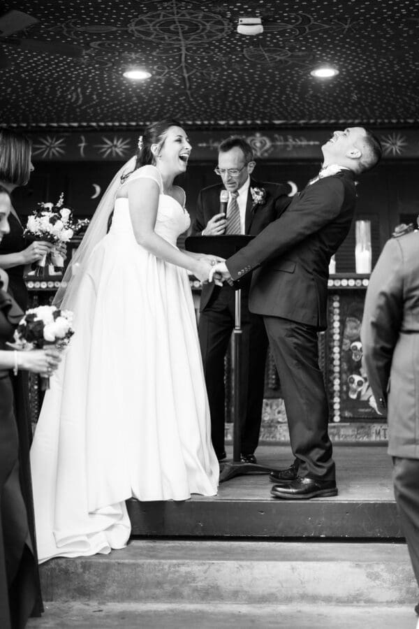 Bride and groom laugh during wedding ceremony at House of Blues