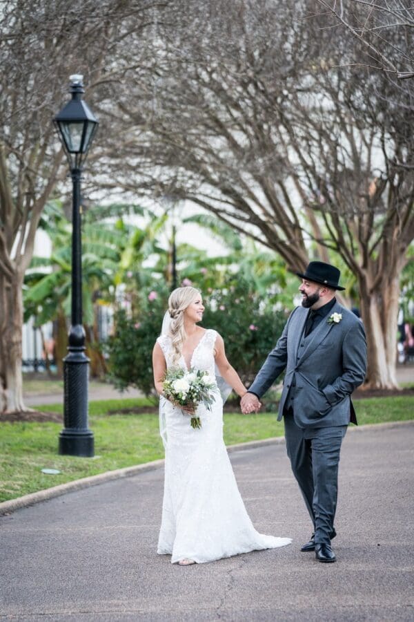 Bride and groom walking through Jackson Square