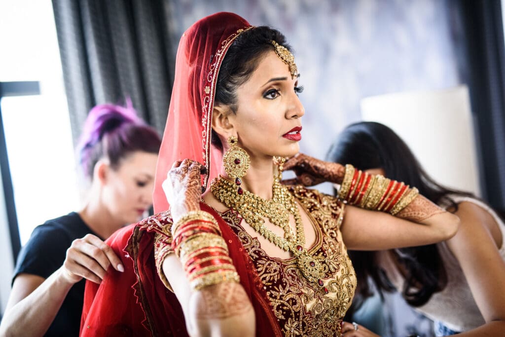 Indian bride getting dressed at JW Marriott wedding