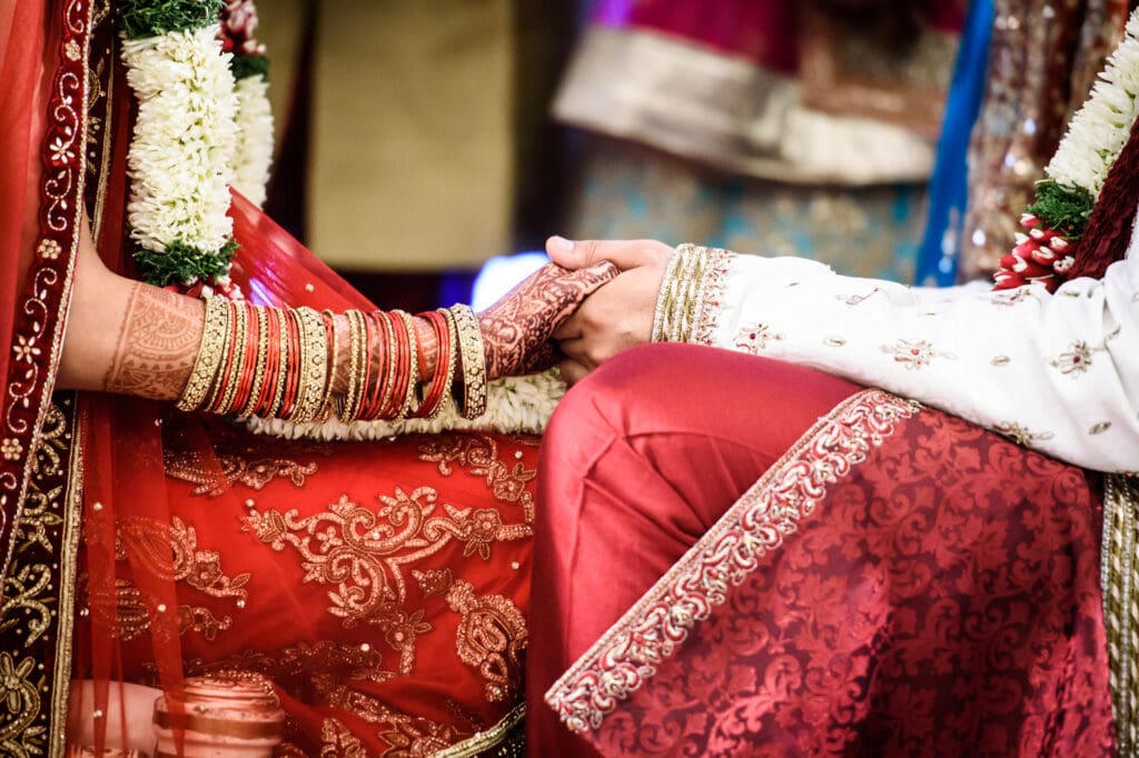 Bride and groom hold hands