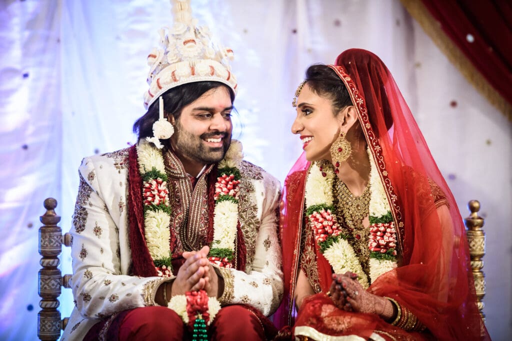 Bride and groom smile at each other during Indian wedding in New Orleans