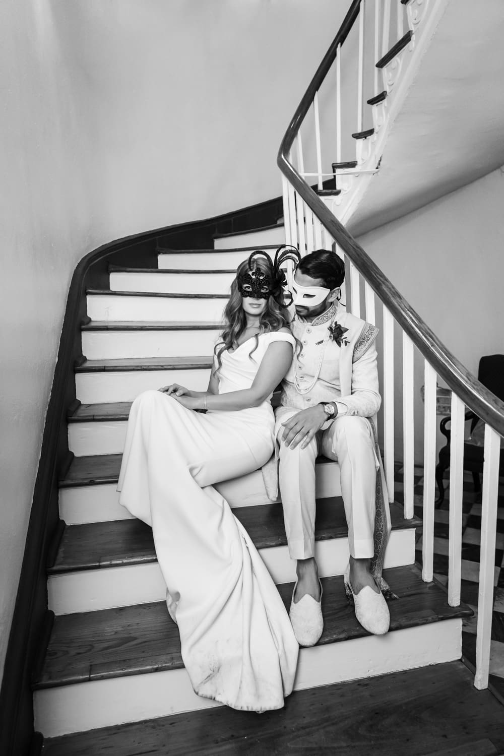 Masked couple sitting on stairs at Latrobe's wedding