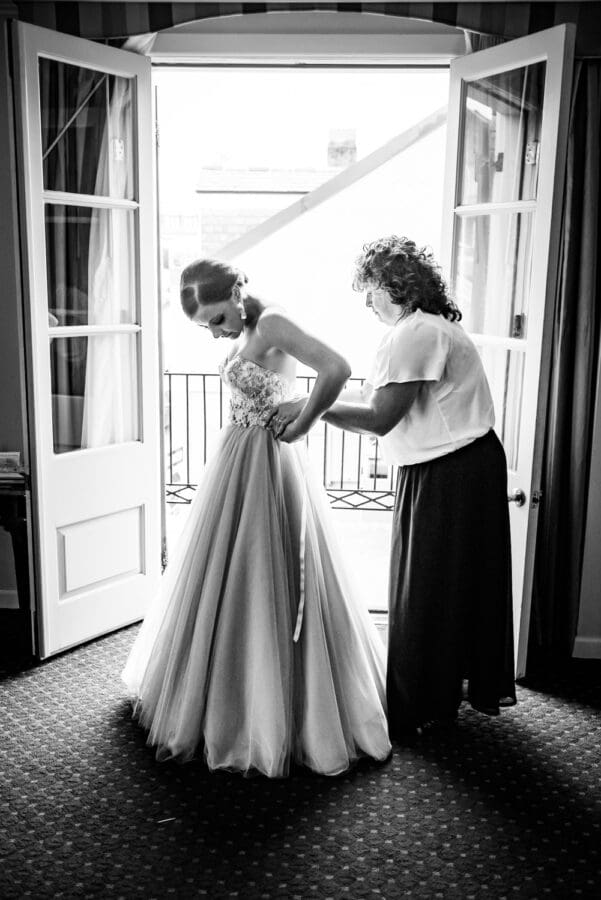 Bride getting dressed at Maison Dupuy Hotel