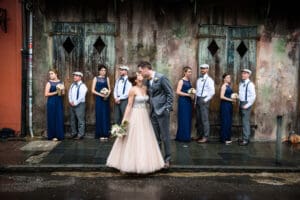 Bride and groom with wedding party in background