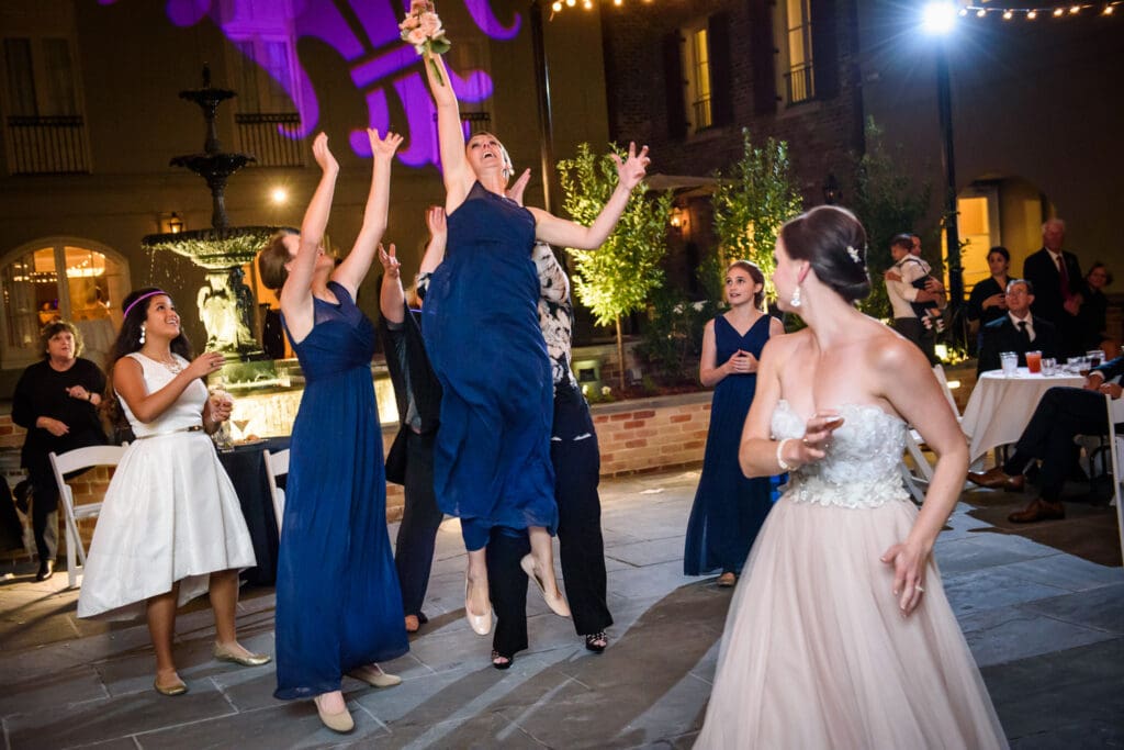 Bridesmaid catches bouquet at Maison Dupuy Hotel wedding