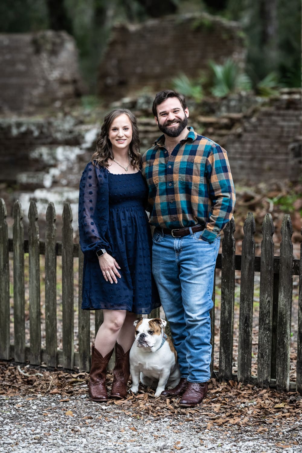 Couple with dog standing in front of sugar mill ruins at Fontainebleau State Park