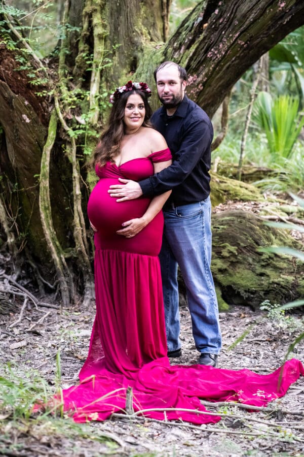 Maternity portrait of mother and father in woods at Fontainebleau State Park in Mandeville