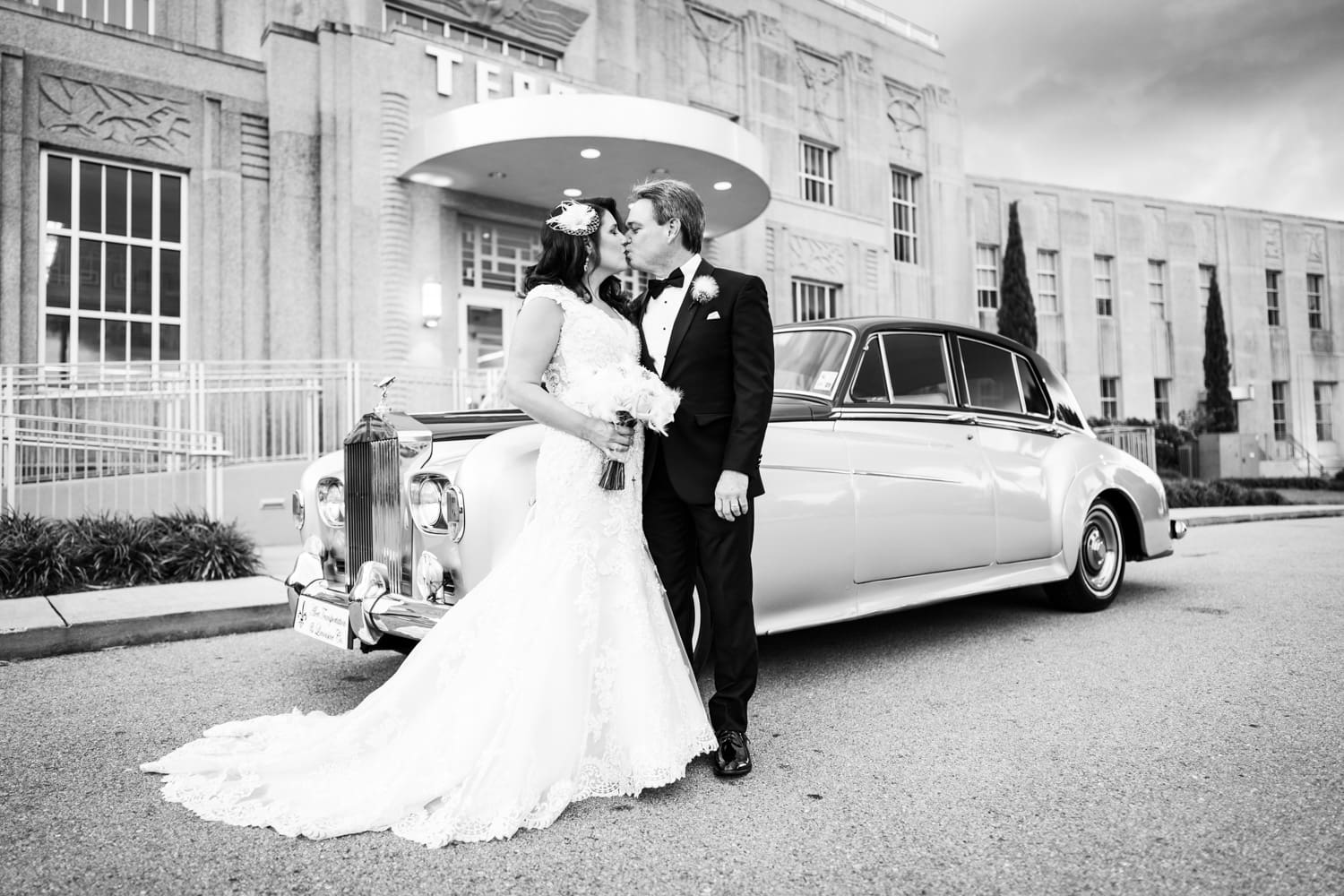 Couple in front of antique Rolls Royce at Lakefront Airport Terminal