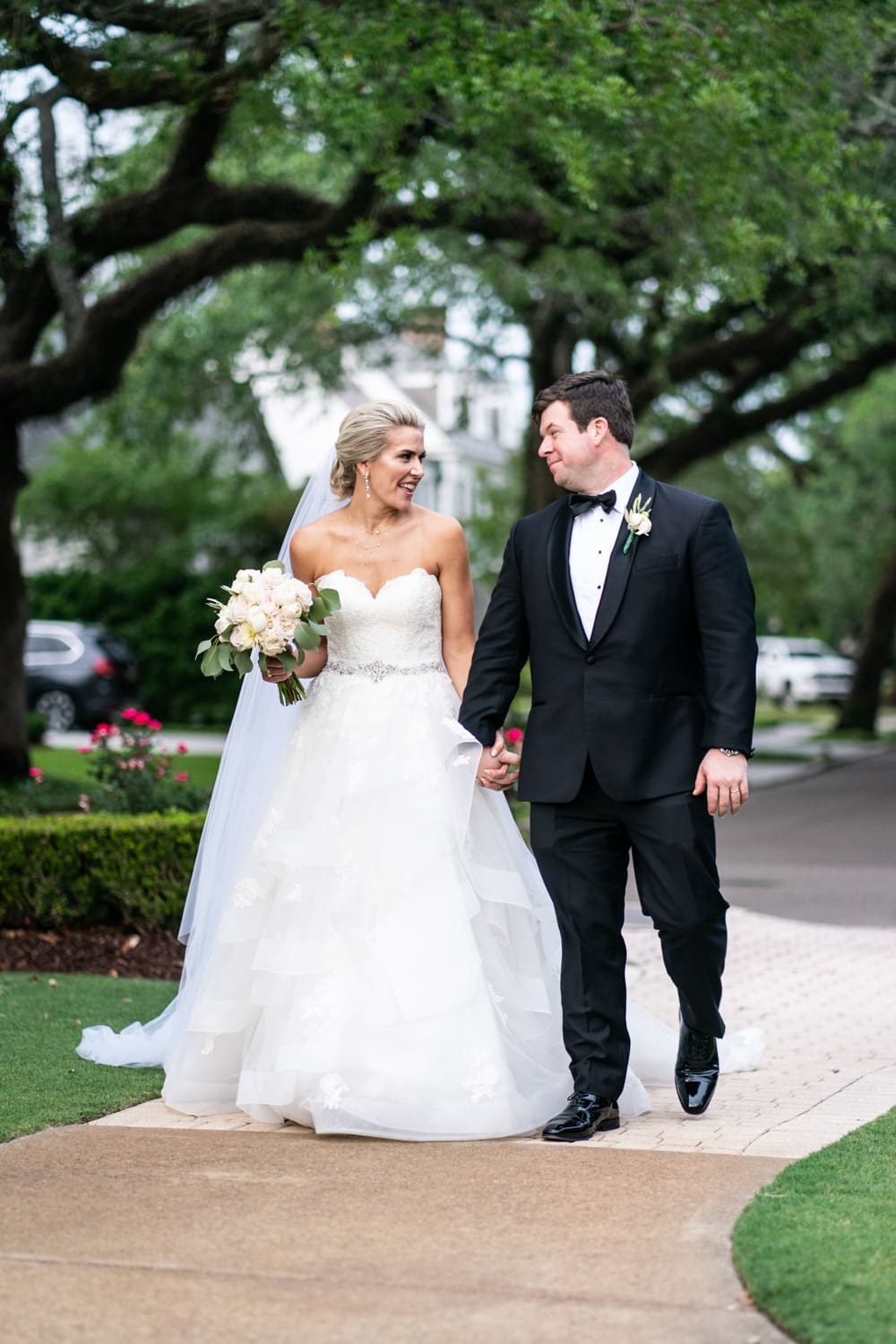 Bride and groom walking at Metairie Country Club wedding