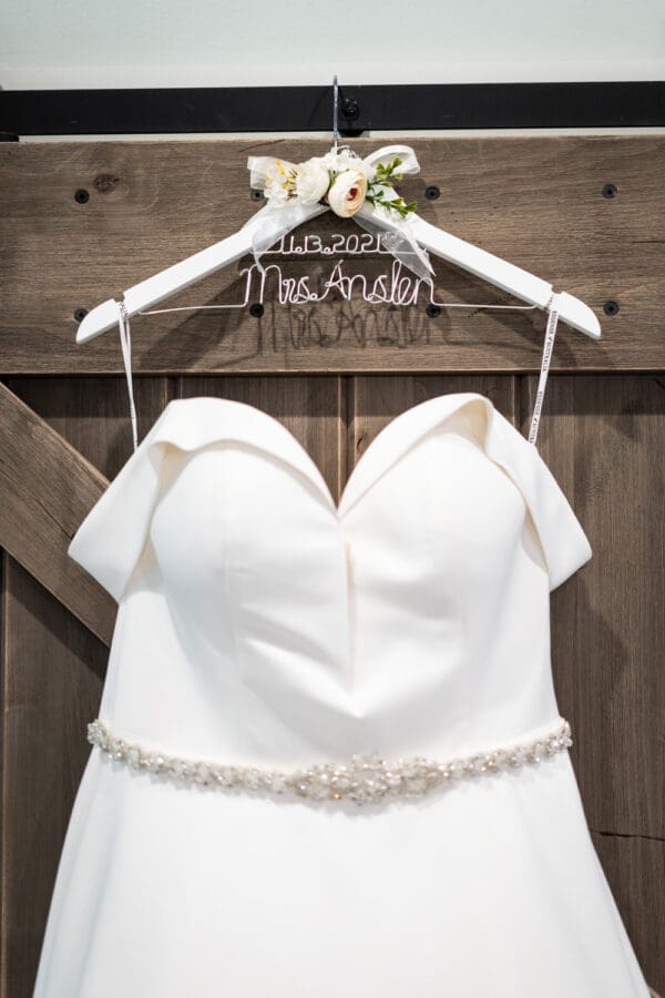 Bride's dress hanging on door