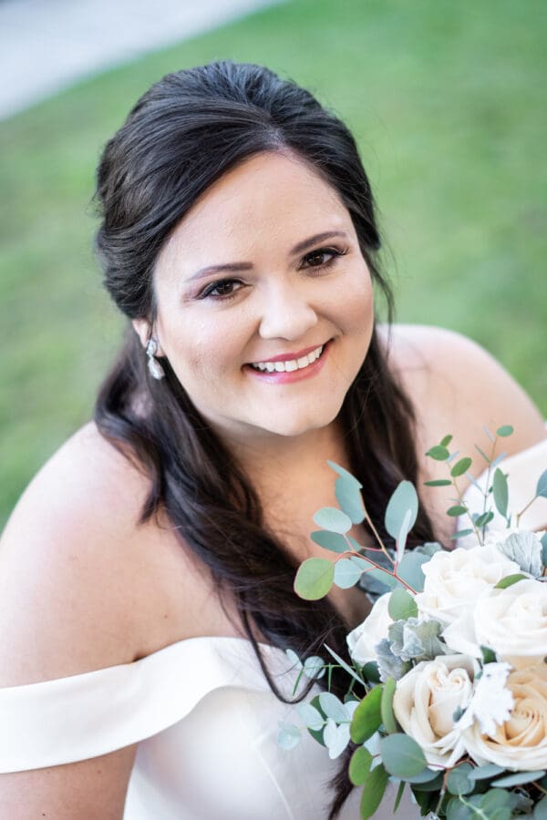 Close-up portrait of bride holding bouquet
