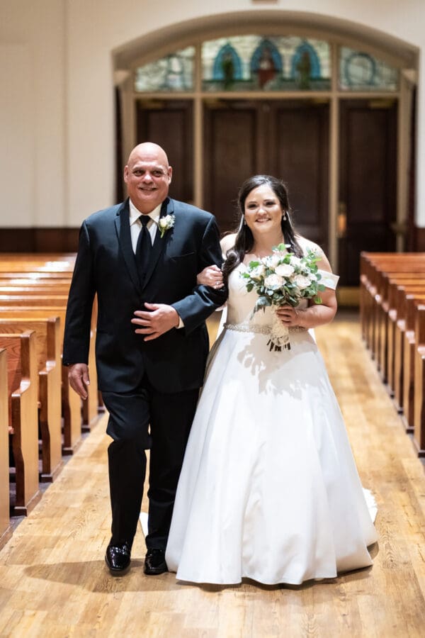 Bride and father walk up the aisle