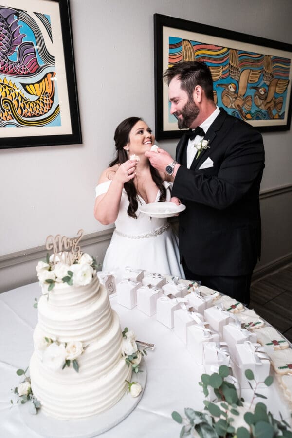 Bride and groom feed each other cake