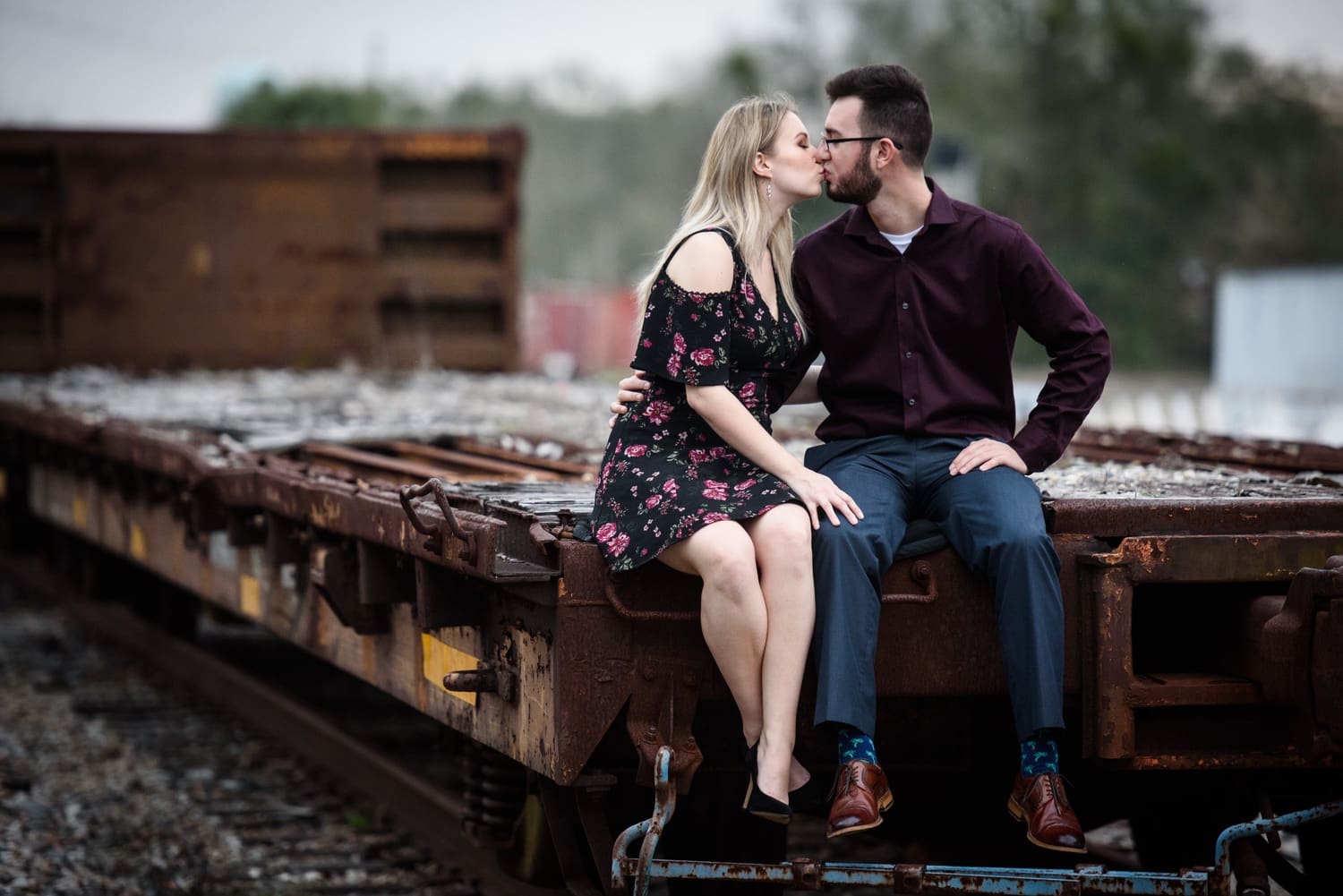 Mississippi engagement portrait of couple sitting on rail car