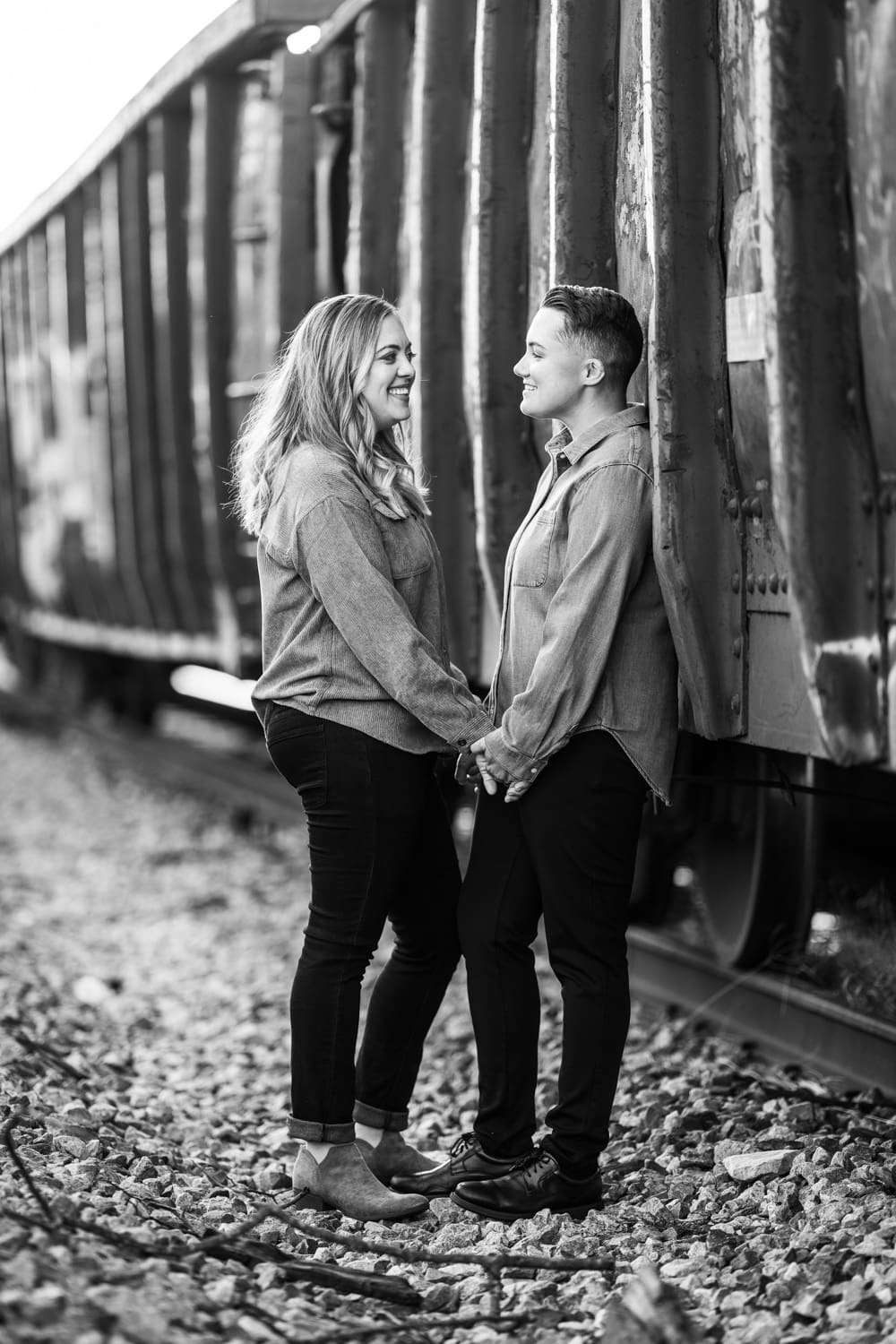 Couple standing by old rail car