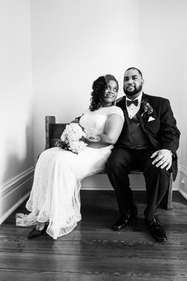 Bride and groom sitting on bench