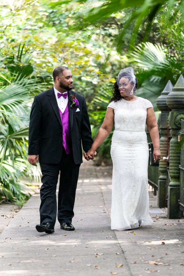 Bride and groom walking along Esplanade Ave.