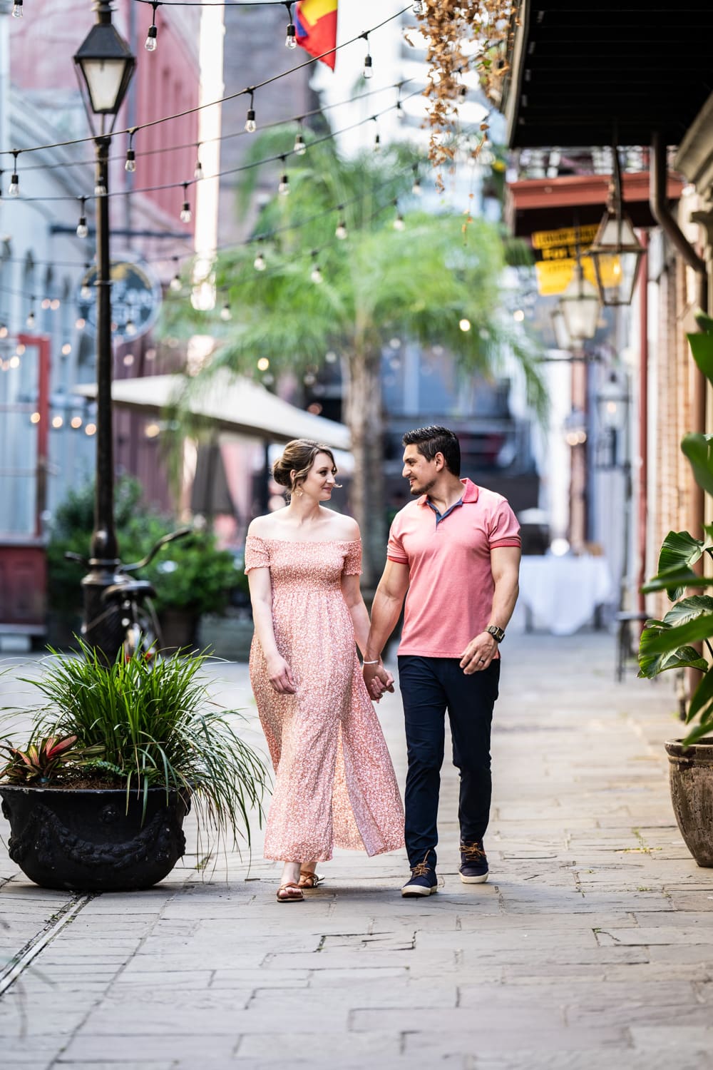 Portrait of couple walking down alley in the French Quarter